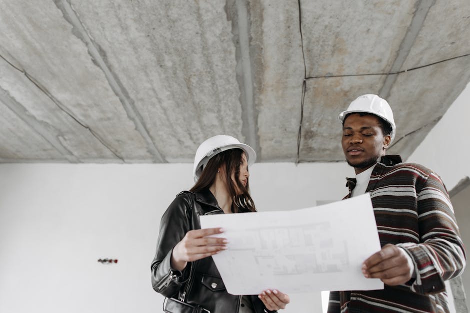 Architect reviewing blueprints and construction drawings for home design